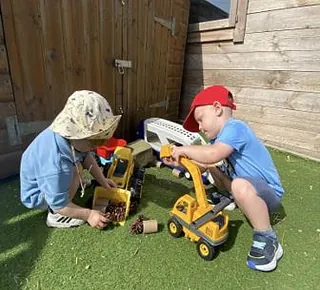 Nursery children playing with diggers